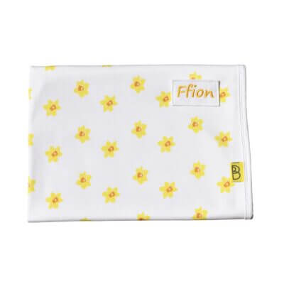 Organic baby blanket with a daffodil yellow print. Add baby's name for a personalised gift!