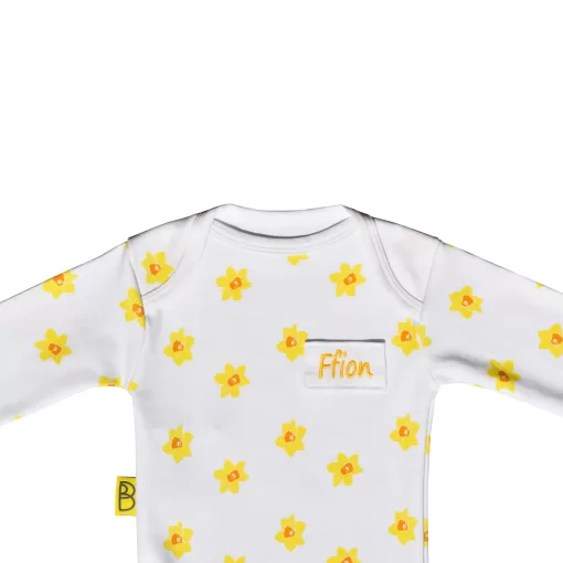 White organic cotton baby long sleeved bodysuit with vibrant daffodil design with two fasteners at bottom can be personalise