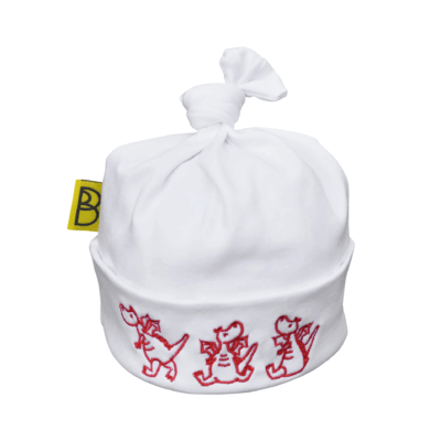 Handmade white Welsh organic cotton baby hat embroidered with three red dragons and made in Wales by Babi Bw