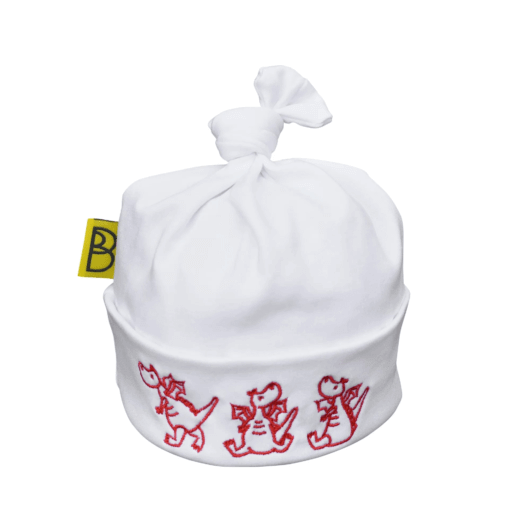 Handmade white Welsh organic cotton baby hat embroidered with three red dragons and made in Wales by Babi Bw