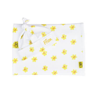 Handmade white organic cotton baby blanket and hat with a vibrant daffodil print they are one size can be personalised