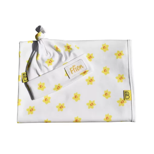 Handmade white organic cotton baby blanket and hat with a vibrant daffodil print they are one size can be personalised