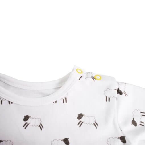 Organic long sleeve T-shirt with hand drawn cute leaping lambs printed on white cotton, with two nickel-free poppers on shoulder for easy changing.