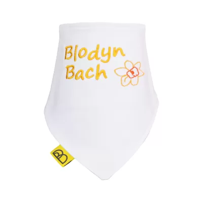 Handmade white Welsh organic cotton baby bib embroidered with Blodyn Bach in yellow and have two fastenings to adjust fit