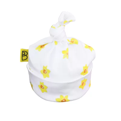 Handmade white organic cotton baby hat with a yellow daffodil design and a knot at the top, can be personalised with name