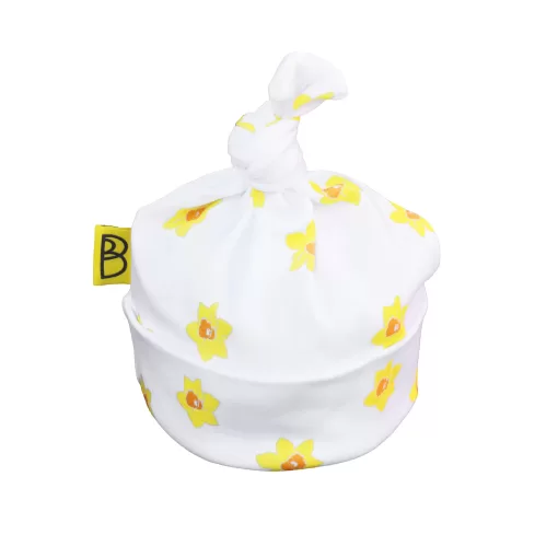 Handmade white organic cotton baby hat with a yellow daffodil design and a knot at the top, can be personalised with name