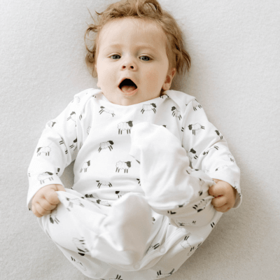 White organic cotton Welsh baby sleepsuit with cute Sheep design fasteners inside legs for easy opening, can be personalised