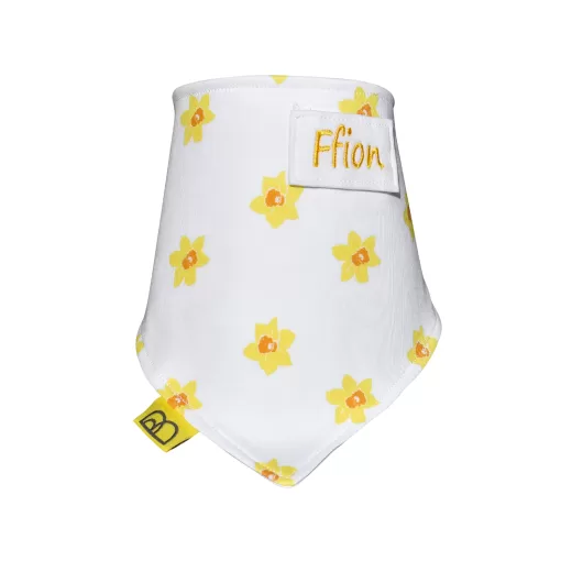 Handmade white organic cotton baby bib with a yellow daffodil print, they are one size and have two fastenings to adjust fit