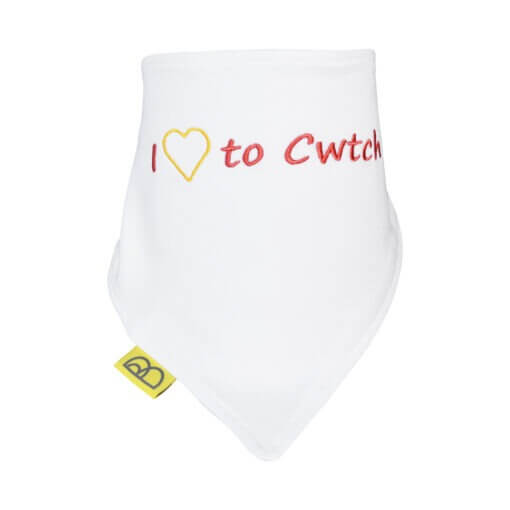 Handmade white Welsh organic cotton baby bib embroidered words I Love to Cwtch in red and have two fastenings to adjust fit