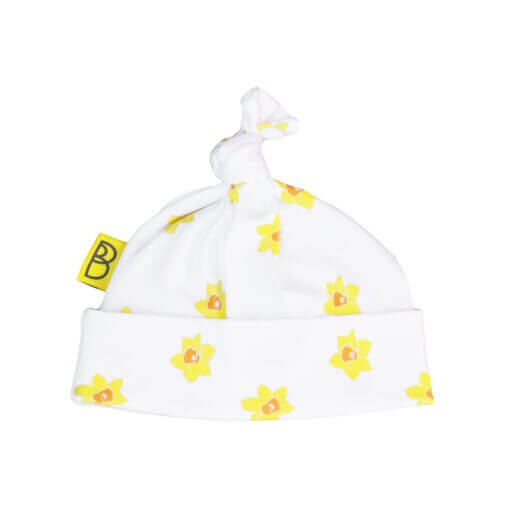 Organic cotton baby hat with vibrant daffodil design printed on to white organic cotton fabric. The baby hat has a cute little hand tied knot on top.