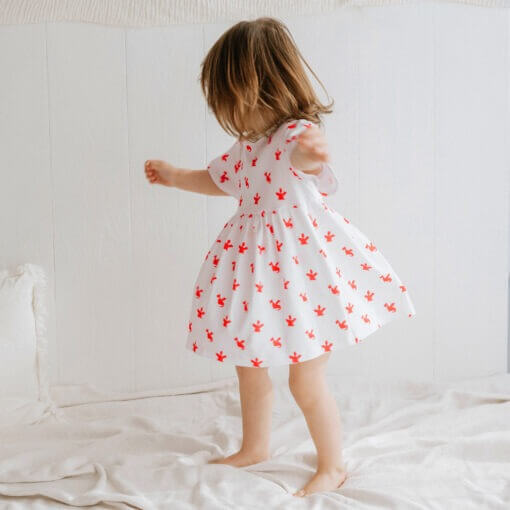 Handmade short sleeve white organic cotton Baby girl dress with cute Welsh red dragon print with two fasteners to adjust back