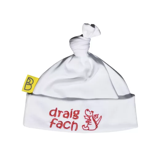 Handmade white Welsh organic cotton baby hat embroidered with words Draig Fach in red and a red dragon