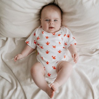 Rugby print short sleeved baby bodysuit in super soft organic cotton.