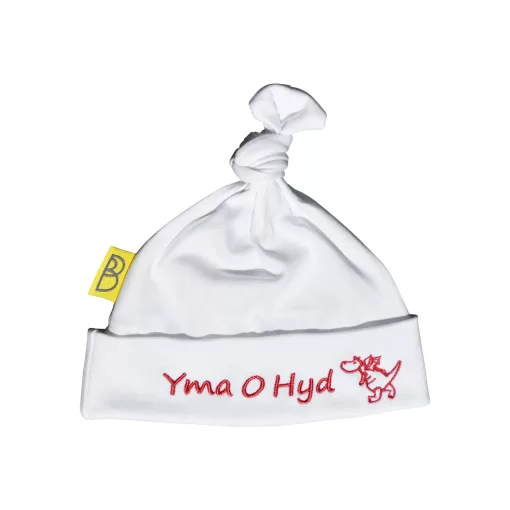 Handmade white Welsh organic cotton baby hat embroidered with words Yma O Hyd in red and a red dragon